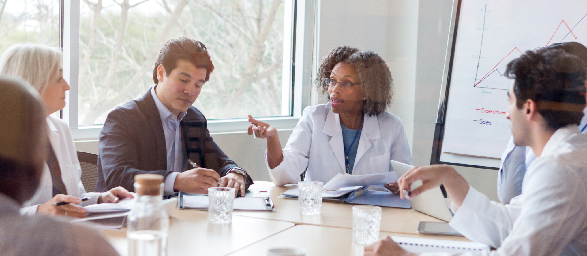 Mature doctor discusses something during conference